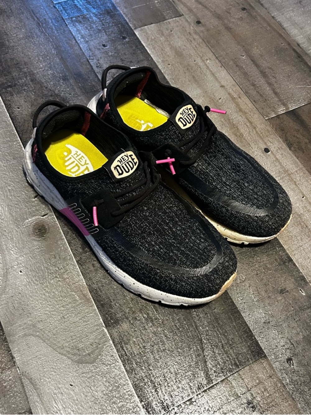 Hey Dude women’s Black Slip-On Sneakers with Pink Details and Yellow Insole